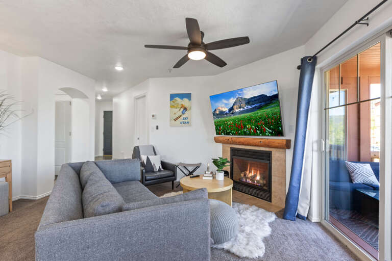 Cozy sofa, fireplace and TV with large window view Cozy sofa, fireplace and TV with large window view