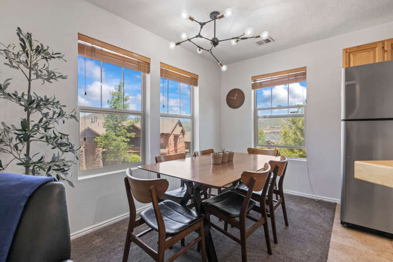 Wide six-seater dining table with large window view Wide six-seater dining table with large window view