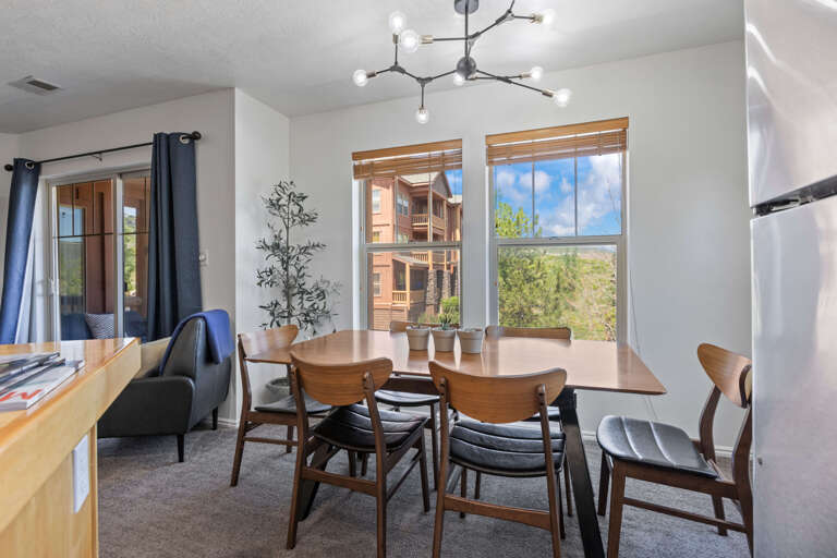 Wide six-seater dining table with large window view Wide six-seater dining table with large window view
