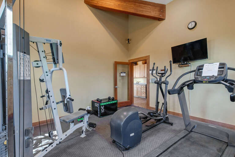 A well-equipped fitness space featuring cardio and strength training equipment, so you can maintain your wellness routine with ease during your stay.