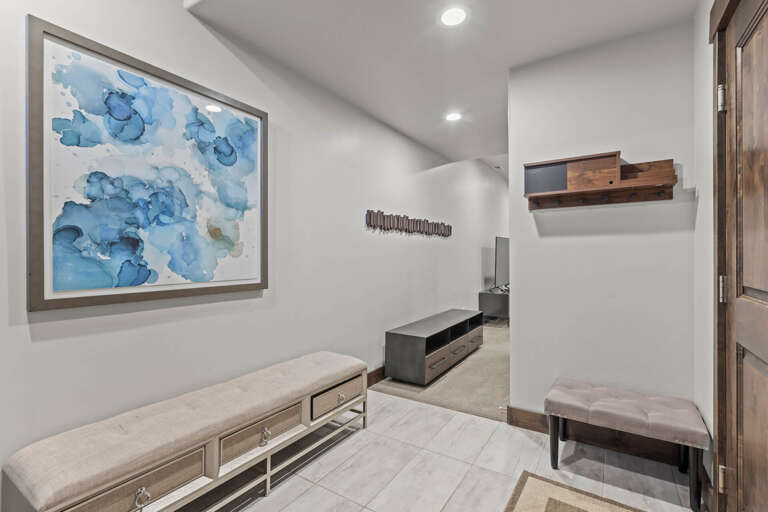 Step into your tranquil entry space, where coastal-inspired artwork and plush seating create an immediate sense of calm and sophistication.