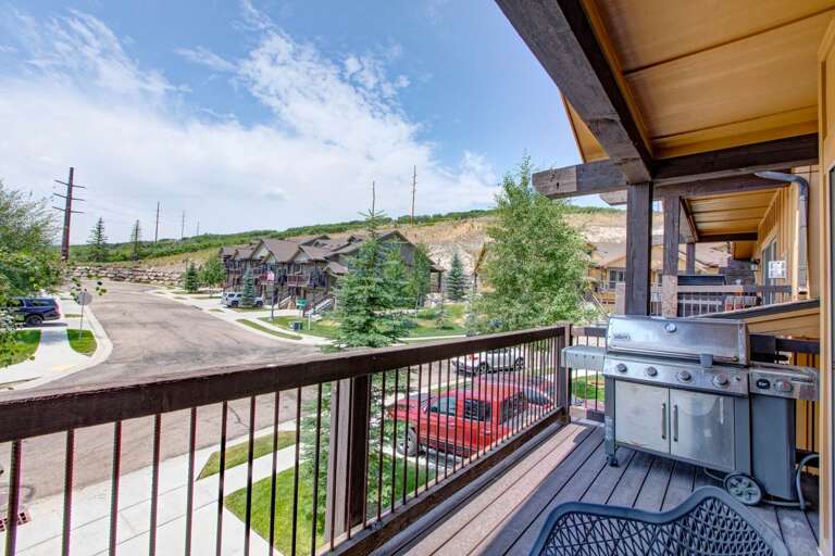 A residential neighborhood nestled in a hillside setting, with the property located along a quiet street surrounded by trees and mountain terrain.