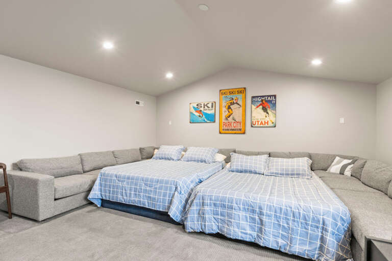 Cozy lower-level retreat with vintage ski art brings alpine charm to your stay. Two plush beds and sectional seating create the perfect space for unwinding after a day on the slopes.