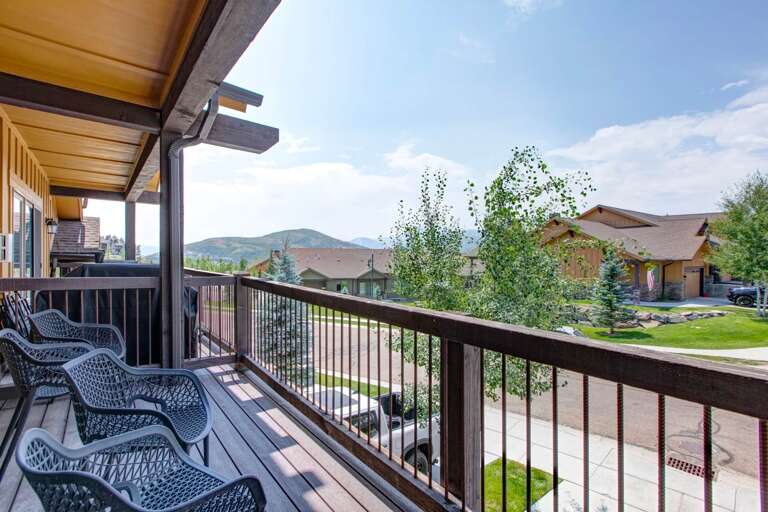 Mountain-view balcony with comfortable outdoor seating for relaxing mornings and evenings in the fresh air.