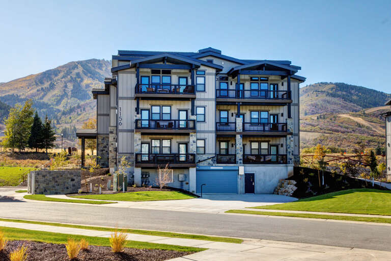 Modern mountain property nestled at the base of scenic slopes, offering stunning mountain views and convenient access to outdoor adventures.