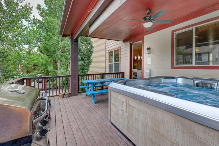 Unwind in your private hot tub on this spacious covered deck, surrounded by lush greenery. Relax under the ceiling fan, grill your favorites, and soak up the peaceful outdoor ambiance.