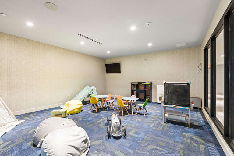 A dedicated playroom awaits your little ones, complete with a slide, colorful chairs, toys, and cozy bean bags—ensuring endless entertainment while you relax nearby.