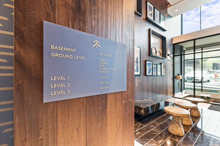 This elegant lobby features a modern directory system that guides you to all amenities, from ski lockers to the gym, all housed within this beautifully designed property.