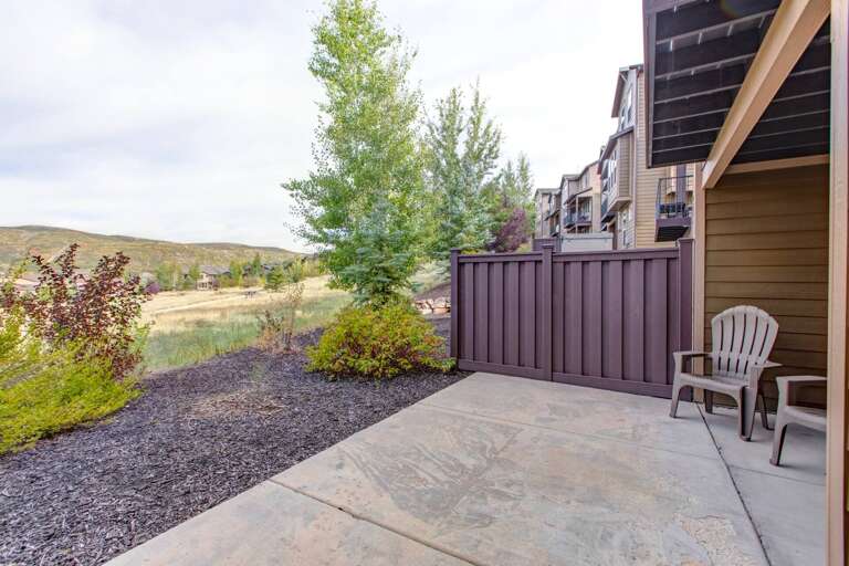 Your private outdoor retreat offers peaceful open hillside views, morning coffee on the patio, and serene landscaped surroundings perfect for unwinding after a day of adventure.