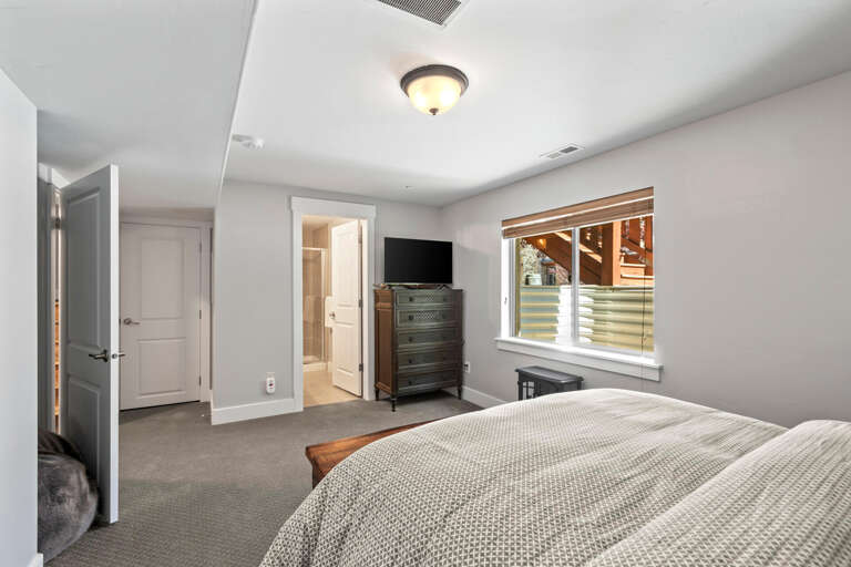 Step into your private retreat with plush carpeting, warm lighting, and a cozy bed dressed in soft linens—your home away from home awaits.