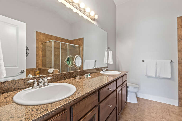Freshen up in your spacious bathroom, complete with dual granite vanities, bright lighting, and a relaxing shower-tub combo for unwinding after a day of adventure.