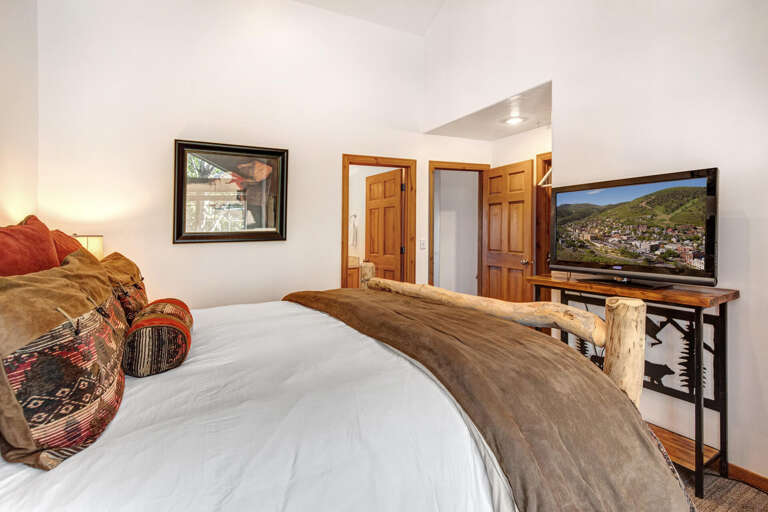 Your peaceful retreat awaits with plush bedding and charming rustic touches, plus entertainment on the flat-screen TV after a day of mountain adventures.