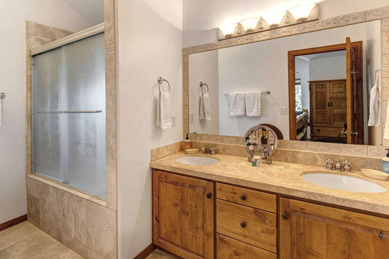 Freshen up in your private bathroom with dual vanities, soft linens, and a spacious shower to start or end your day feeling renewed.