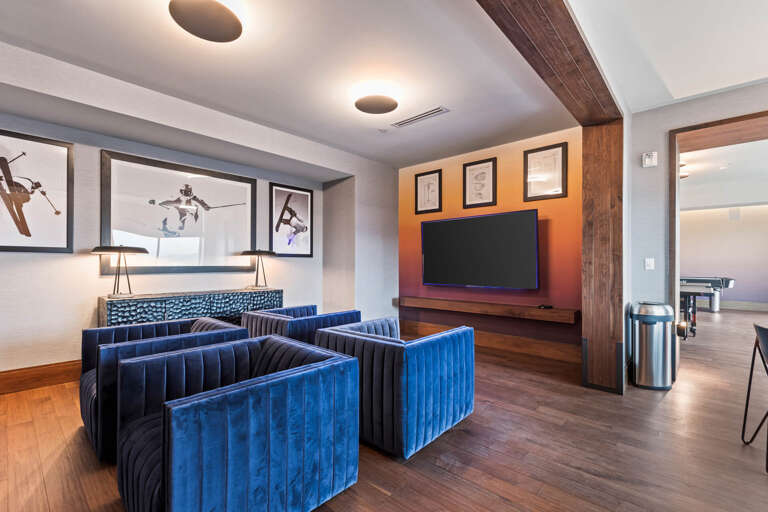 Sink into plush velvet seating and unwind with your favorite shows on the big screen. Rich wood tones and modern lighting create a cozy, stylish retreat for movie nights.
