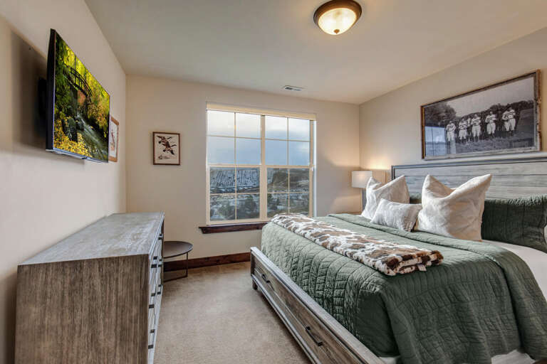 Relax in your cozy bedroom with soft linens and a peaceful mountain view. Wake up to natural light and enjoy your favorite shows on the flat-screen TV.