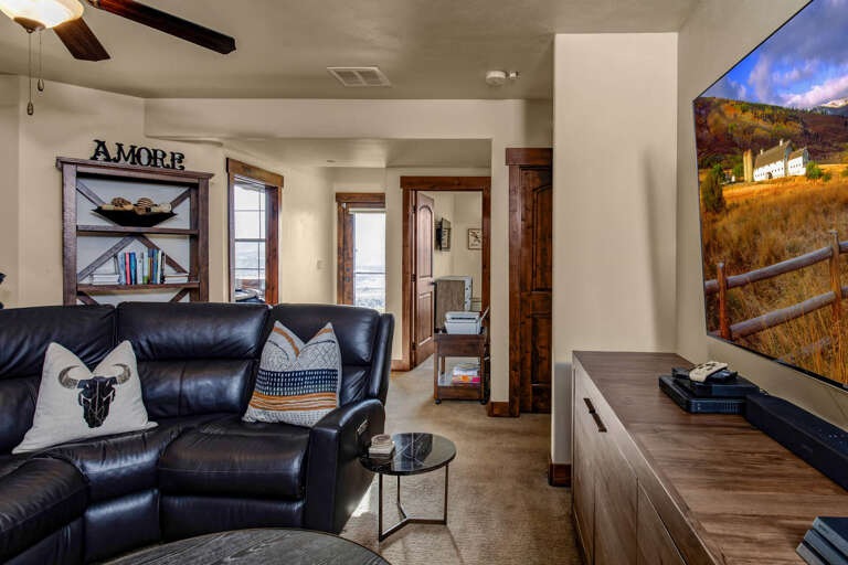 Unwind on the plush leather sofa while streaming your favorites on the large flat-screen TV. The cozy room blends rustic charm with modern comfort, perfect for your mountain getaway.