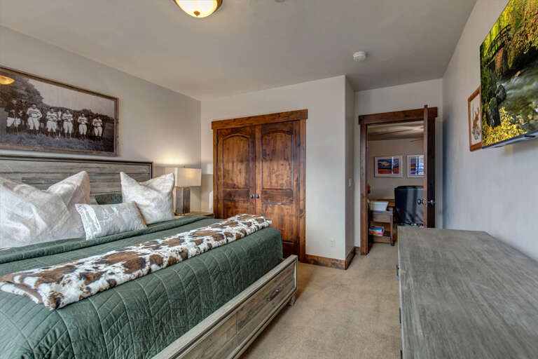 Sink into plush pillows and cozy quilted bedding. Your peaceful retreat awaits with warm wood accents, thoughtful artwork, and ample storage for all your getaway essentials.