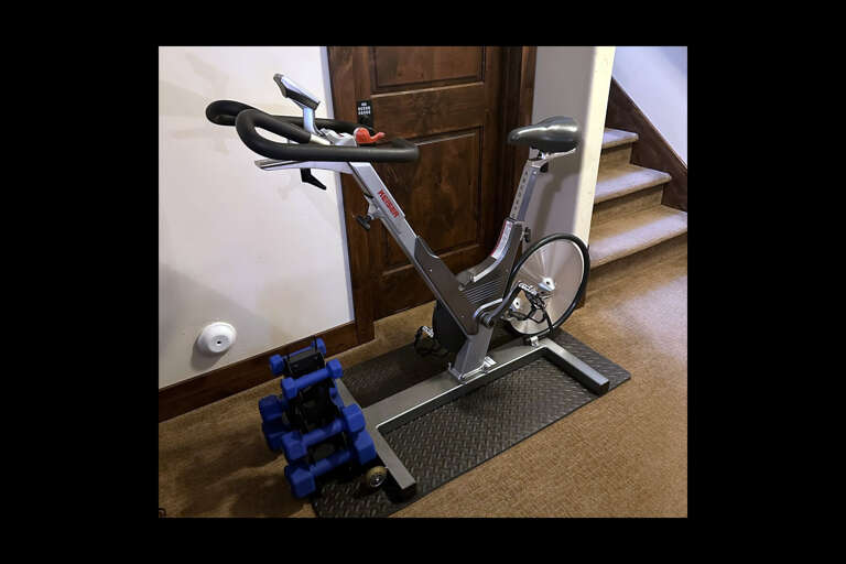 Stay active during your getaway with your own in-home fitness setup featuring a stationary bike and free weights, ready whenever you need a quick workout.