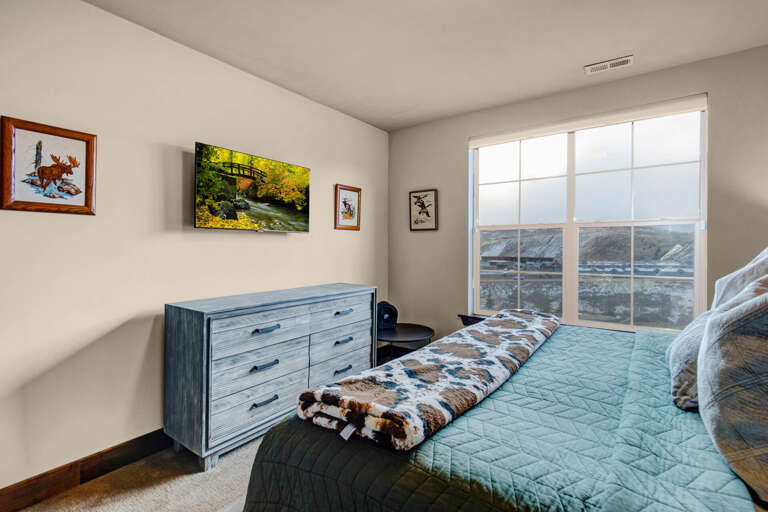 Wake up to stunning mountain vistas from your restful bedroom, where thoughtful décor and comfortable bedding invite you to unwind after a day of exploring.