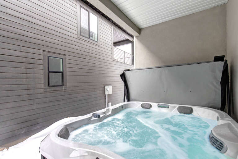 Soak away the day in your private hot tub, nestled in a peaceful courtyard space designed just for your relaxation and comfort.