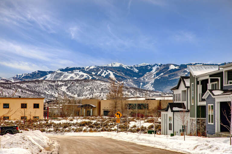 Property located in a scenic winter setting with snow-capped mountains visible in the background, offering ski resort access nearby.