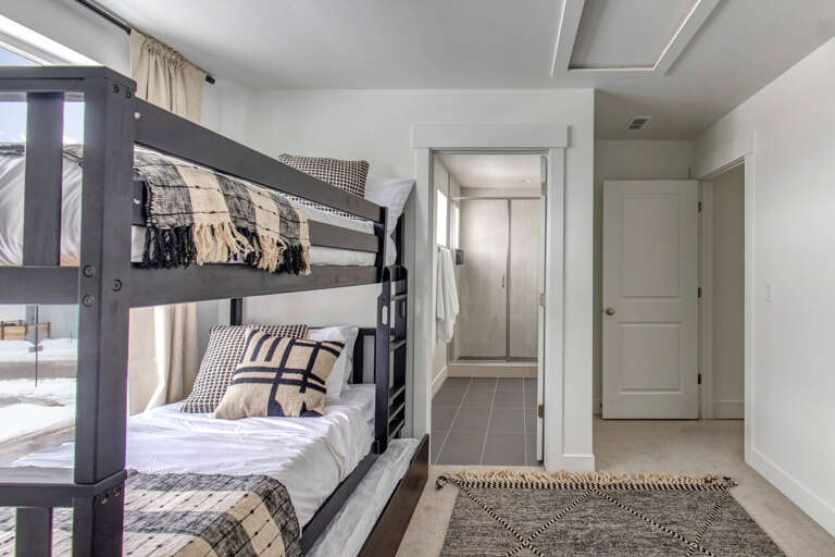 Your cozy bunk room invites restful nights with crisp linens, modern design, and a serene space perfect for families or friends sharing unforgettable memories together.