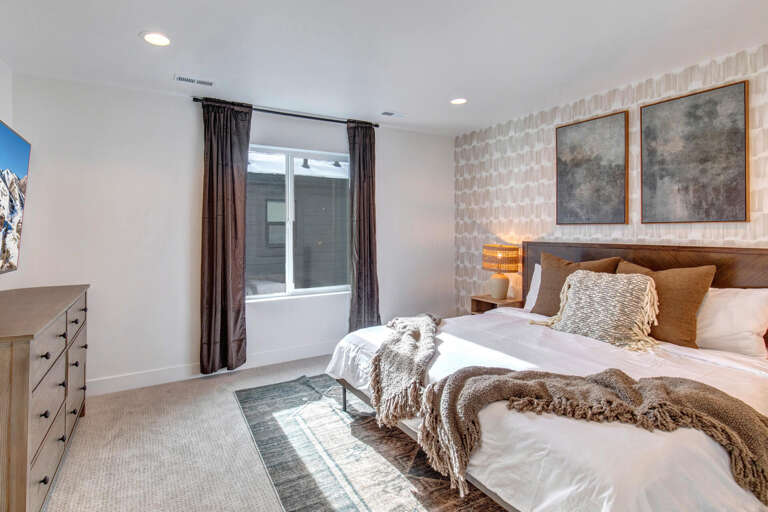 Sink into plush layers and soft textures in your thoughtfully designed bedroom retreat, featuring a cozy bed, modern furnishings, and natural light to refresh your days.