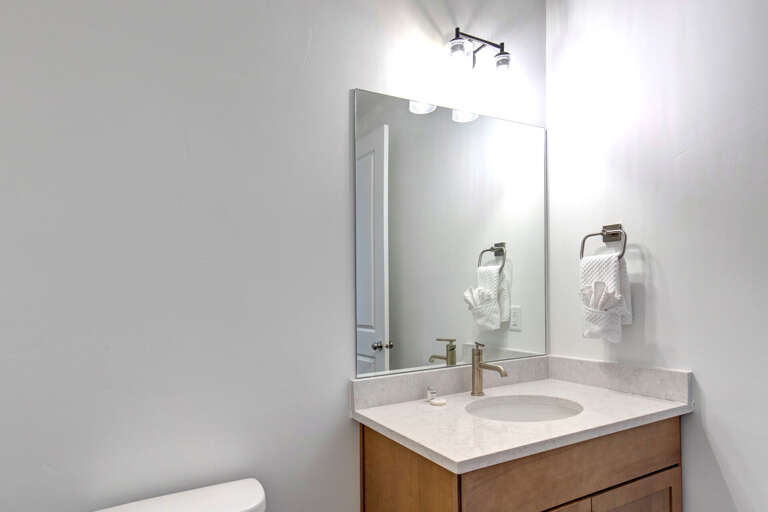 Step into your bright, modern bathroom with a spotless vanity and soft towels ready for your refreshing morning routine.