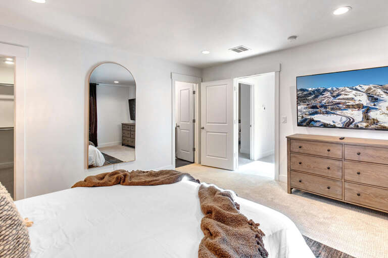 Sink into crisp white linens and wake up to stunning mountain views. Your private retreat features plush bedding, generous storage, and a full-length mirror for easy morning prep.
