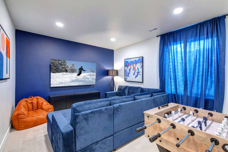 Unwind in your private entertainment haven with plush seating, a foosball table, and large-screen TV—perfect for game nights and relaxing after exploring the slopes.