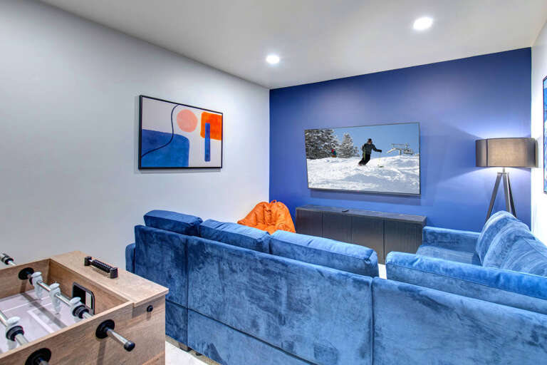 Sink into plush velvet sofas and enjoy your favorite shows on the big screen—perfect for cozy movie nights after a day on the slopes.