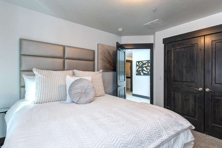 Sink into your cozy king bed with plush linens and enjoy the serene neutral tones. Your private suite includes elegant wardrobe storage and connects to your own ensuite bathroom.