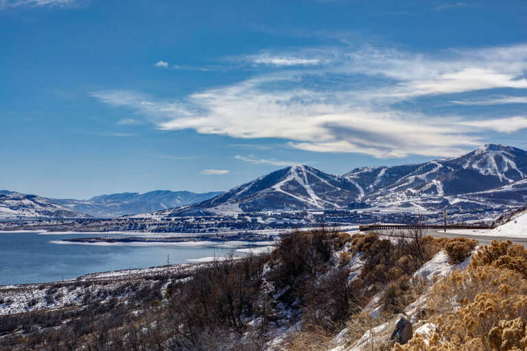 Stunning mountain scenery frames the property's location, with snow-capped peaks and a serene lake creating a picturesque winter backdrop for your mountain getaway.