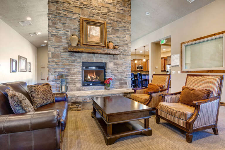 Sink into plush seating by the stone fireplace and feel the warmth wrap around you—your cozy retreat after a day of adventure awaits here.