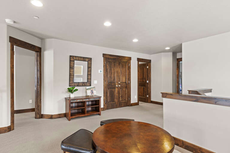 This spacious upper-level area invites you to unwind with its warm wood accents, soft carpeting, and bright natural light. You'll appreciate the thoughtful design—open yet cozy, perfect for your getaway.
