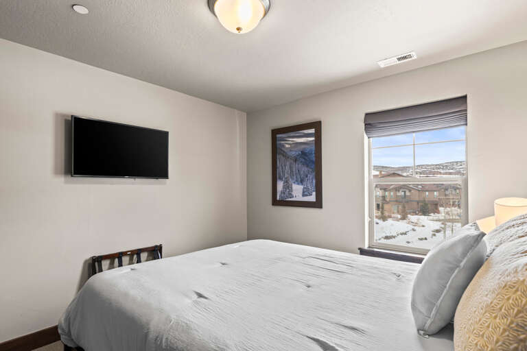 Wake up to stunning mountain views from your cozy bedroom. The flat-screen TV and soft linens create the perfect retreat after a day exploring the area.