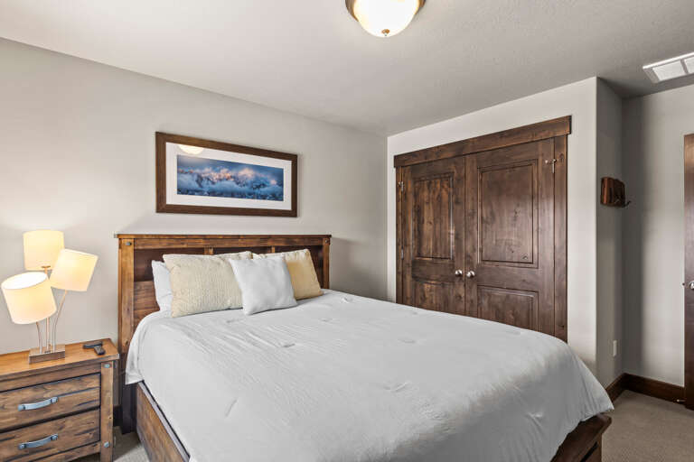 Sink into crisp linens and rustic warmth in your peaceful retreat, where mountain-inspired design meets modern comfort for the perfect night's rest.