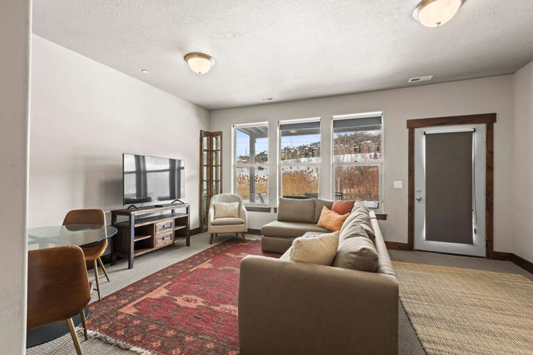 Sink into your cozy living room sofa and enjoy scenic mountain views through expansive windows that frame the natural beauty surrounding your retreat.