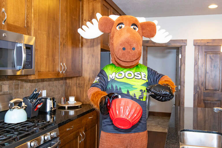 Your fully equipped kitchen features modern appliances, granite countertops, and warm wood cabinetry—everything you need to whip up delicious meals during your mountain escape.