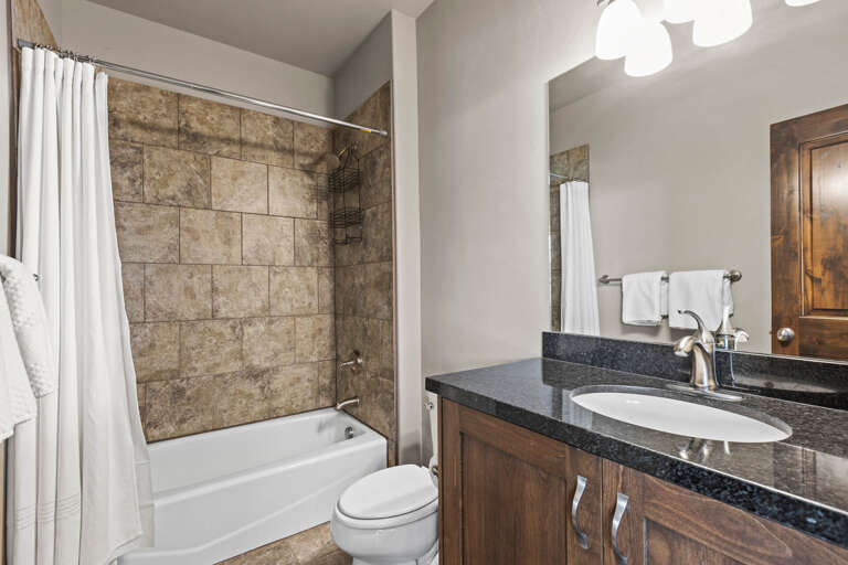 Refresh in your well-appointed bathroom with a soothing tub-shower combo, polished countertops, and plush towels ready for your arrival.