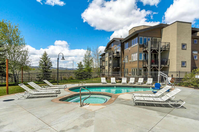 This inviting resort-style pool area is surrounded by mountain views and sunny skies—perfect for soaking up the scenery and unwinding after a day of exploration.