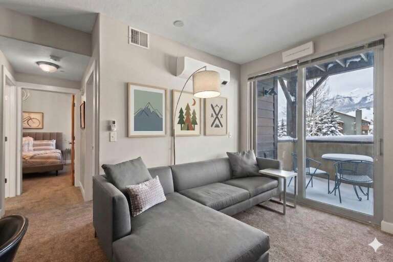 Unwind on your plush sectional sofa while taking in mountain views from your private balcony - your perfect alpine retreat awaits.