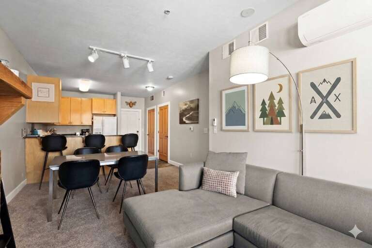 Unwind in your stylish open-concept space where the cozy living room flows seamlessly into a modern kitchen and dining area.