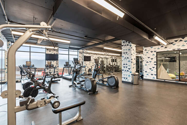 Stay active and energized in your modern fitness center, featuring state-of-the-art cardio equipment, strength training stations, and inspiring water views through expansive windows. Your wellness routine just got easier.