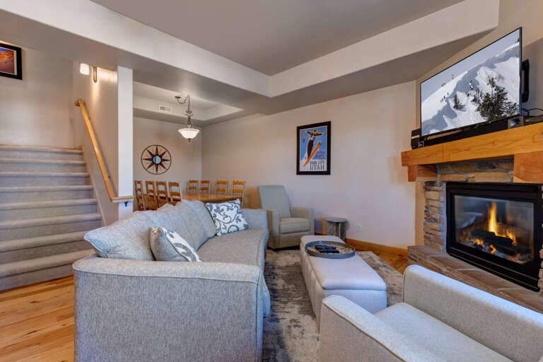Unwind in your cozy living room where the stone fireplace creates perfect warmth for relaxing evenings.