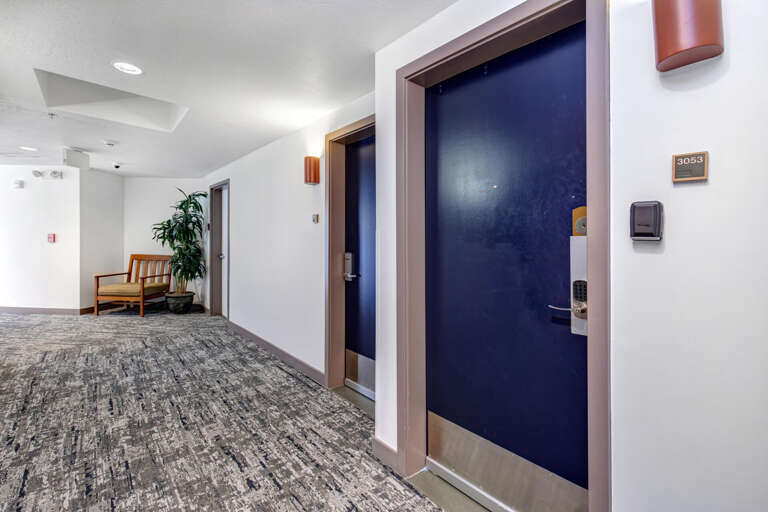 Clean, modern hallway with contemporary design details and convenient digital entry to your private retreat.