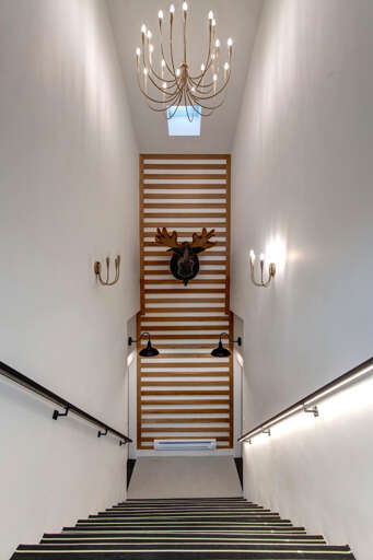 Ascend this stunning staircase where modern elegance meets rustic charm, with dramatic lighting and unique dÃ©cor creating an unforgettable entrance.