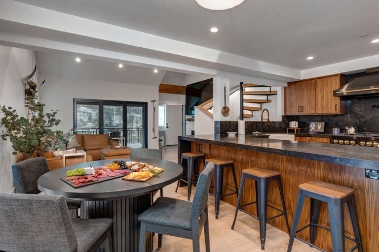 Gather around the sleek dining table or cozy up at the kitchen island in this stunning open-concept space designed for connection.