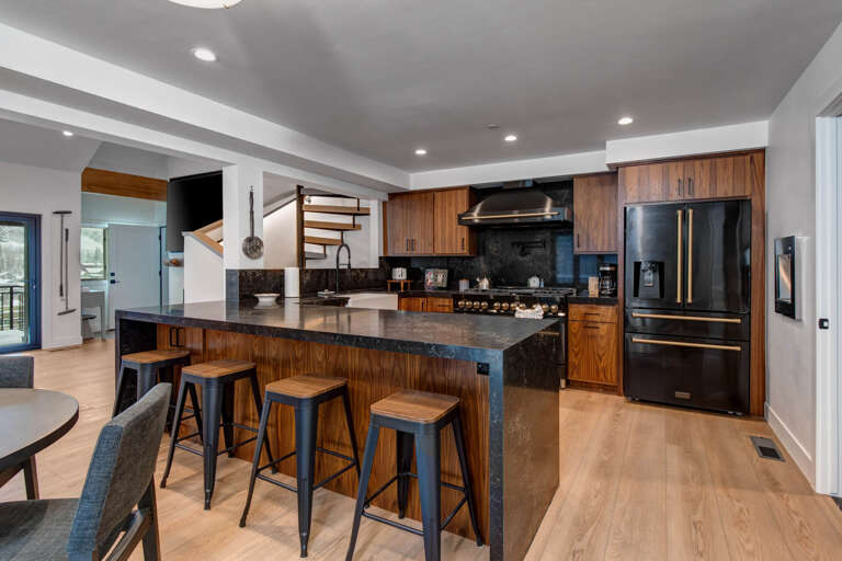 Your gourmet kitchen awaits with rich wood cabinetry, sleek granite counters, and stainless steel appliances perfect for culinary adventures together.