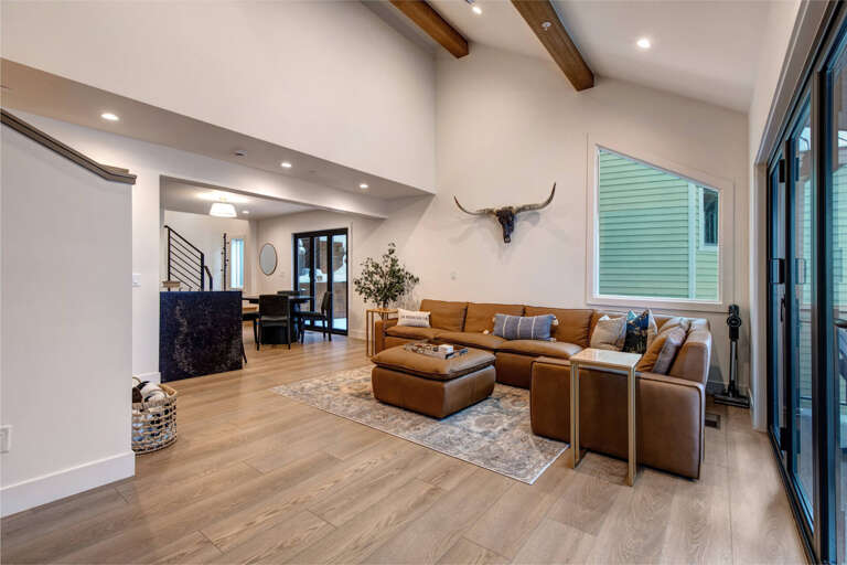 Sink into this plush leather sectional where rustic beams meet modern elegance, perfect for your evening unwind sessions.